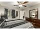 Sleek bedroom with a bed, dresser, ceiling fan, and windows with curtains at 4850 E Desert Cove Ave # 227, Scottsdale, AZ 85254