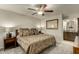 Cozy bedroom features a ceiling fan, carpeted floor, and convenient access to the ensuite bathroom at 4850 E Desert Cove Ave # 227, Scottsdale, AZ 85254