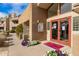 Inviting building entrance with well-maintained landscaping, fresh flowers, and visible community information at 4850 E Desert Cove Ave # 227, Scottsdale, AZ 85254