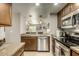 Well-equipped kitchen featuring stainless steel appliances and a view into the living room at 4850 E Desert Cove Ave # 227, Scottsdale, AZ 85254