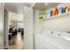 Bright laundry room with shelving and full-size washer and dryer at 4850 E Desert Cove Ave # 227, Scottsdale, AZ 85254