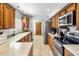 Galley kitchen with tiled floors and countertops, stainless steel appliances, and ample cabinet space at 520 W Port Royale Ln, Phoenix, AZ 85023