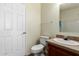 Bathroom featuring a white toilet and sink with brown cabinets at 53040 W Whirly Bird Rd, Maricopa, AZ 85139