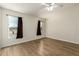 Bright bedroom featuring hardwood floors, neutral walls, and a window that lets in natural light at 53040 W Whirly Bird Rd, Maricopa, AZ 85139