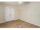 Bedroom features wood-look flooring and a double door closet for storage at 53040 W Whirly Bird Rd, Maricopa, AZ 85139