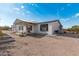 Exterior shot of a desert home with an attached garage and awning at 53040 W Whirly Bird Rd, Maricopa, AZ 85139