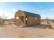 Small cabin featuring a porch with wooden rails with desert landscape and clear skies in the background at 53040 W Whirly Bird Rd, Maricopa, AZ 85139