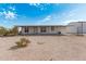 Single story home on desert lot featuring covered porch and blue sky backdrop at 53040 W Whirly Bird Rd, Maricopa, AZ 85139