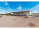 Single story home with a long covered porch and desert landscaping at 53040 W Whirly Bird Rd, Maricopa, AZ 85139