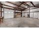 Metal garage interior featuring a white garage door and a concrete floor at 53040 W Whirly Bird Rd, Maricopa, AZ 85139