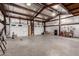 Metal garage interior featuring two white garage doors with concrete flooring at 53040 W Whirly Bird Rd, Maricopa, AZ 85139