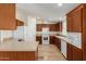 Bright kitchen with white appliances, wood cabinets, and ample counter space at 53040 W Whirly Bird Rd, Maricopa, AZ 85139