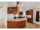 Well-equipped kitchen with wood cabinets, a breakfast bar, and white appliances at 53040 W Whirly Bird Rd, Maricopa, AZ 85139