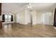 Spacious living room with light wood floors, ceiling fans, and vaulted ceilings at 53040 W Whirly Bird Rd, Maricopa, AZ 85139
