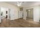 Spacious bedroom with wood flooring, closet with mirrors, and bathroom access at 53040 W Whirly Bird Rd, Maricopa, AZ 85139