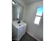 Bathroom vanity featuring a sink, mirror, modern lighting, and a window at 538 S 98Th St, Mesa, AZ 85208