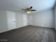 Bedroom featuring plush carpeting, a ceiling fan, and three doors at 538 S 98Th St, Mesa, AZ 85208