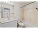 Bright bathroom featuring a tub with shower, single sink vanity, and neutral finishes at 6121 S Ruby Dr, Chandler, AZ 85249