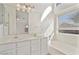 Bright bathroom with double vanity, large mirror, and combined shower and tub at 6121 S Ruby Dr, Chandler, AZ 85249
