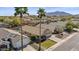 Charming single-story home with well-maintained landscaping, palm trees, and a beautiful desert backdrop at 6121 S Ruby Dr, Chandler, AZ 85249