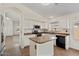 Bright kitchen featuring an island, black appliances, white cabinets, and tile flooring at 6121 S Ruby Dr, Chandler, AZ 85249