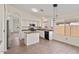 Bright kitchen featuring an island, white cabinets, and tile flooring at 6121 S Ruby Dr, Chandler, AZ 85249