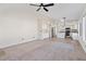 Open living space with carpet, a ceiling fan, and a view of the kitchen at 6121 S Ruby Dr, Chandler, AZ 85249