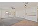 Open living space featuring neutral carpet, a ceiling fan, and ample natural light at 6121 S Ruby Dr, Chandler, AZ 85249