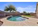 Inviting private pool with cool blue tile trim and concrete deck, set against a backdrop of mature landscaping and fencing at 6121 S Ruby Dr, Chandler, AZ 85249