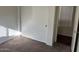 Bedroom featuring carpet flooring, double door closet, and natural light from a window at 6531 W Hess S St, Phoenix, AZ 85043
