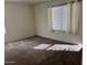 Bedroom featuring carpet and a window with blinds and curtains at 6531 W Hess S St, Phoenix, AZ 85043