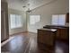 Sunlit living space featuring wood floors, a central island, and a view of the kitchen area at 6531 W Hess S St, Phoenix, AZ 85043