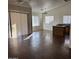 Bright living room with wood floors, high ceilings, and lots of natural light from multiple windows at 6531 W Hess S St, Phoenix, AZ 85043