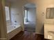 Bathroom with a soaking tub, single vanity, and view into bedroom at 6531 W Hess S St, Phoenix, AZ 85043