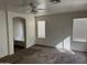 Bright main bedroom featuring neutral carpet, archway to bathroom, and natural light from two windows at 6531 W Hess S St, Phoenix, AZ 85043
