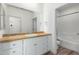 Bright bathroom features a wood countertop, large mirror, and white cabinetry at 7101 W Beardsley Rd # 722, Glendale, AZ 85308
