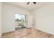This bright bedroom has wood floors, a ceiling fan and access to a balcony with neighborhood views at 7101 W Beardsley Rd # 722, Glendale, AZ 85308
