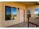 The exterior of a well-maintained building with desert landscaping and a light pink front door at 7101 W Beardsley Rd # 722, Glendale, AZ 85308