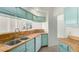 Updated kitchen showcasing butcher block countertops, light teal cabinets, and a stainless steel sink at 7101 W Beardsley Rd # 722, Glendale, AZ 85308