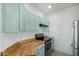 This kitchen features light blue cabinets, butcher block countertops, and stainless steel appliances at 7101 W Beardsley Rd # 722, Glendale, AZ 85308