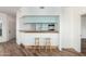 Breakfast bar with seating adjacent to a modern kitchen with plenty of storage space at 7101 W Beardsley Rd # 722, Glendale, AZ 85308