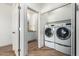 A white washer and dryer set sit in a laundry area visible from an open doorway at 7101 W Beardsley Rd # 722, Glendale, AZ 85308