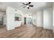 Bright living room featuring wood floors, a ceiling fan, and access to a balcony with natural light at 7101 W Beardsley Rd # 722, Glendale, AZ 85308