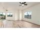 Bright, open living area with wood flooring, natural light, and access to the outside balcony at 7101 W Beardsley Rd # 722, Glendale, AZ 85308