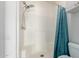 This newly renovated shower has bright white tile and a shower curtain at 7101 W Beardsley Rd # 722, Glendale, AZ 85308