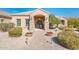 Elegant front entrance featuring a stone archway, custom wood doors, and manicured landscaping at 720 E Seattle Slew Ln, Gilbert, AZ 85296