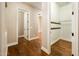 Hallway features wood floors and a walk-in closet with built in shelving at 720 E Seattle Slew Ln, Gilbert, AZ 85296