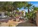 Serene backyard oasis featuring mature trees, a decorative fountain, and a cozy patio area at 721 W Cherrywood Dr, Chandler, AZ 85248