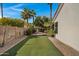 Expansive backyard with artificial turf, mature landscaping, and privacy fencing, perfect for outdoor living at 721 W Cherrywood Dr, Chandler, AZ 85248