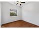 Bedroom featuring wood floors, white walls, and a window overlooking the yard at 721 W Cherrywood Dr, Chandler, AZ 85248